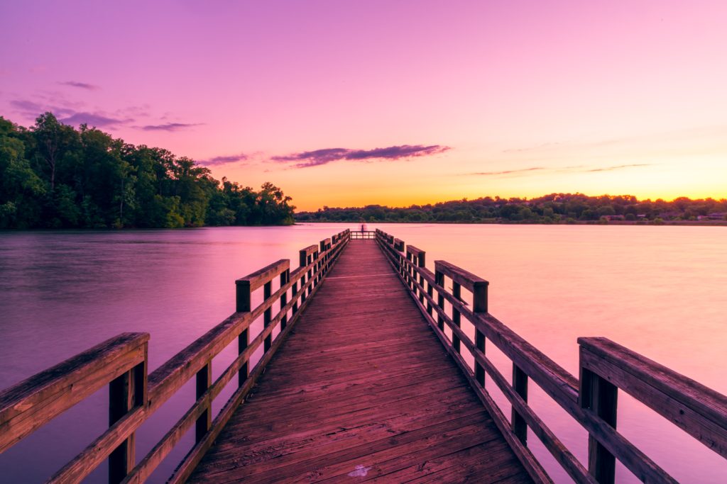 sunrise on a like and pier